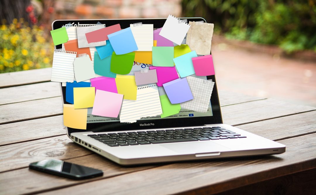 laptop with all the sticky notes- balance your life