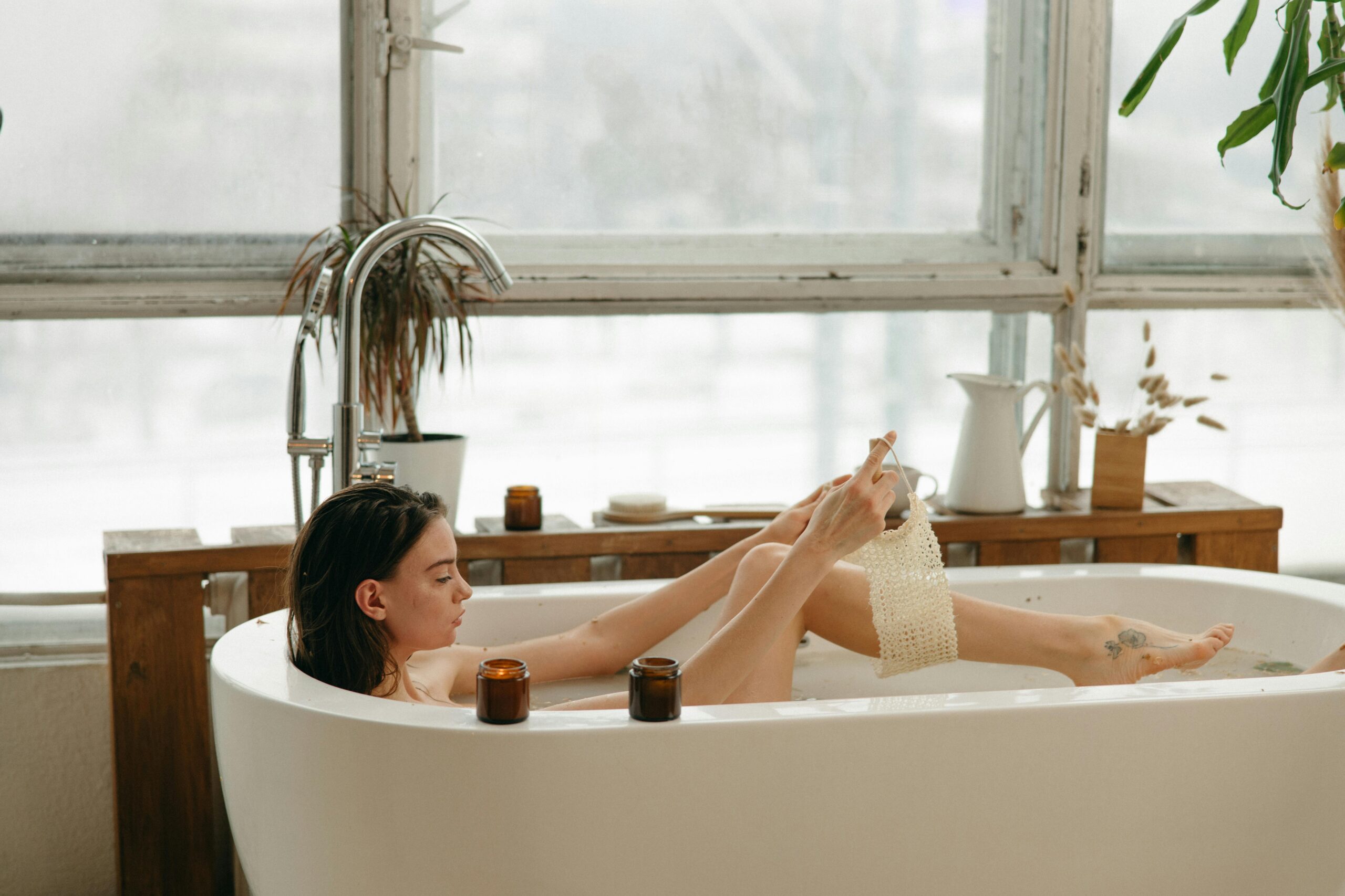 Woman enjoying an aesthetic minimalist routine with a calm intentional bath ritual