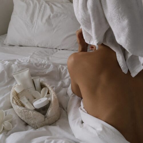 woman on her bed ready to do her facial treatments