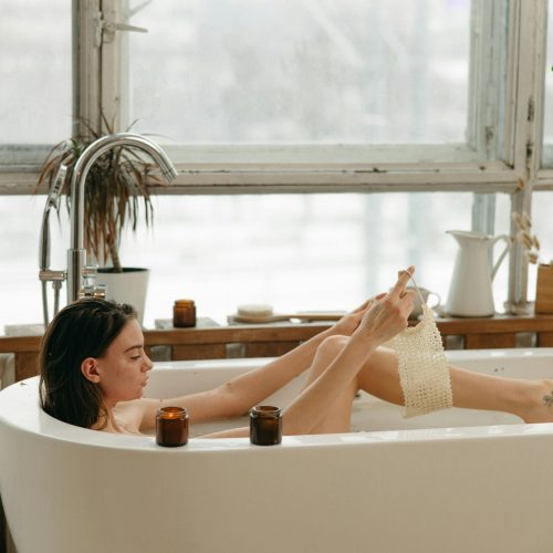 Woman enjoying an aesthetic minimalist routine with a calm intentional bath ritual